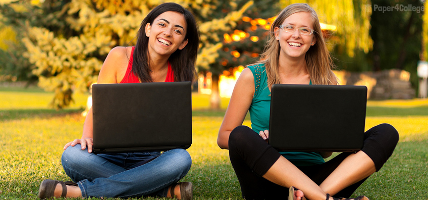 Two Smiling Students with Laptops